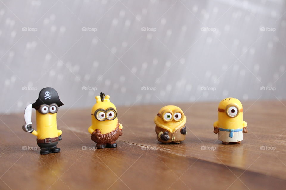 four minions on wooden table