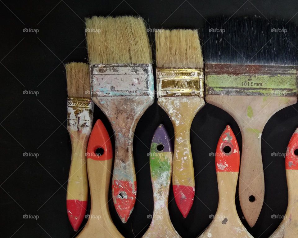 paintbrushes. black background