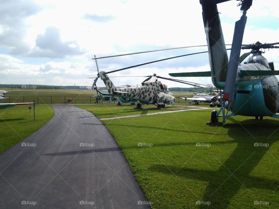 The helicopter is flying against the blue sky.