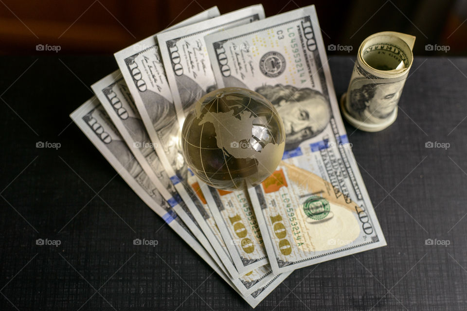 transparent globe on dollars