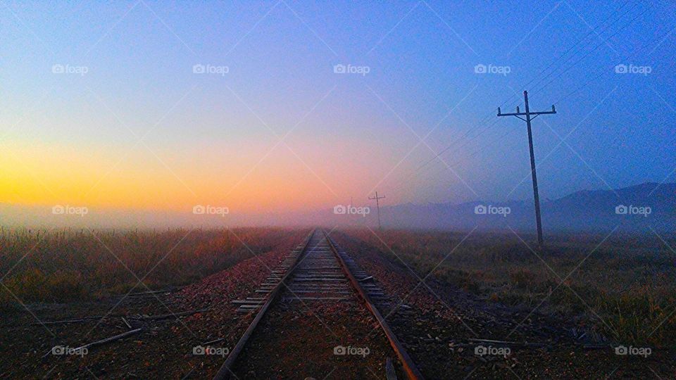 sunrise train tracks fog