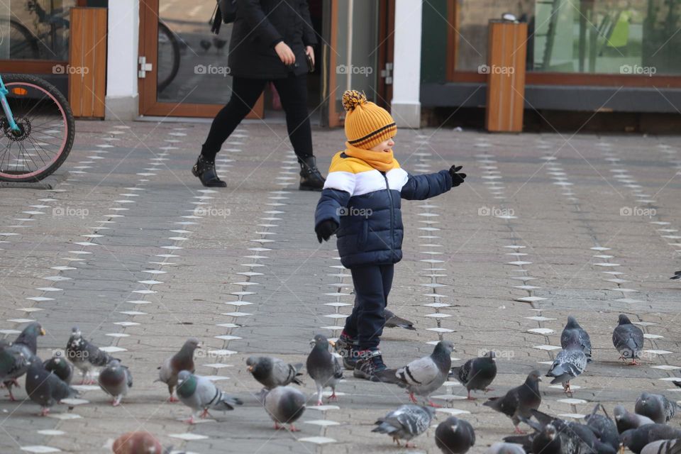 The boy playing at the pavement