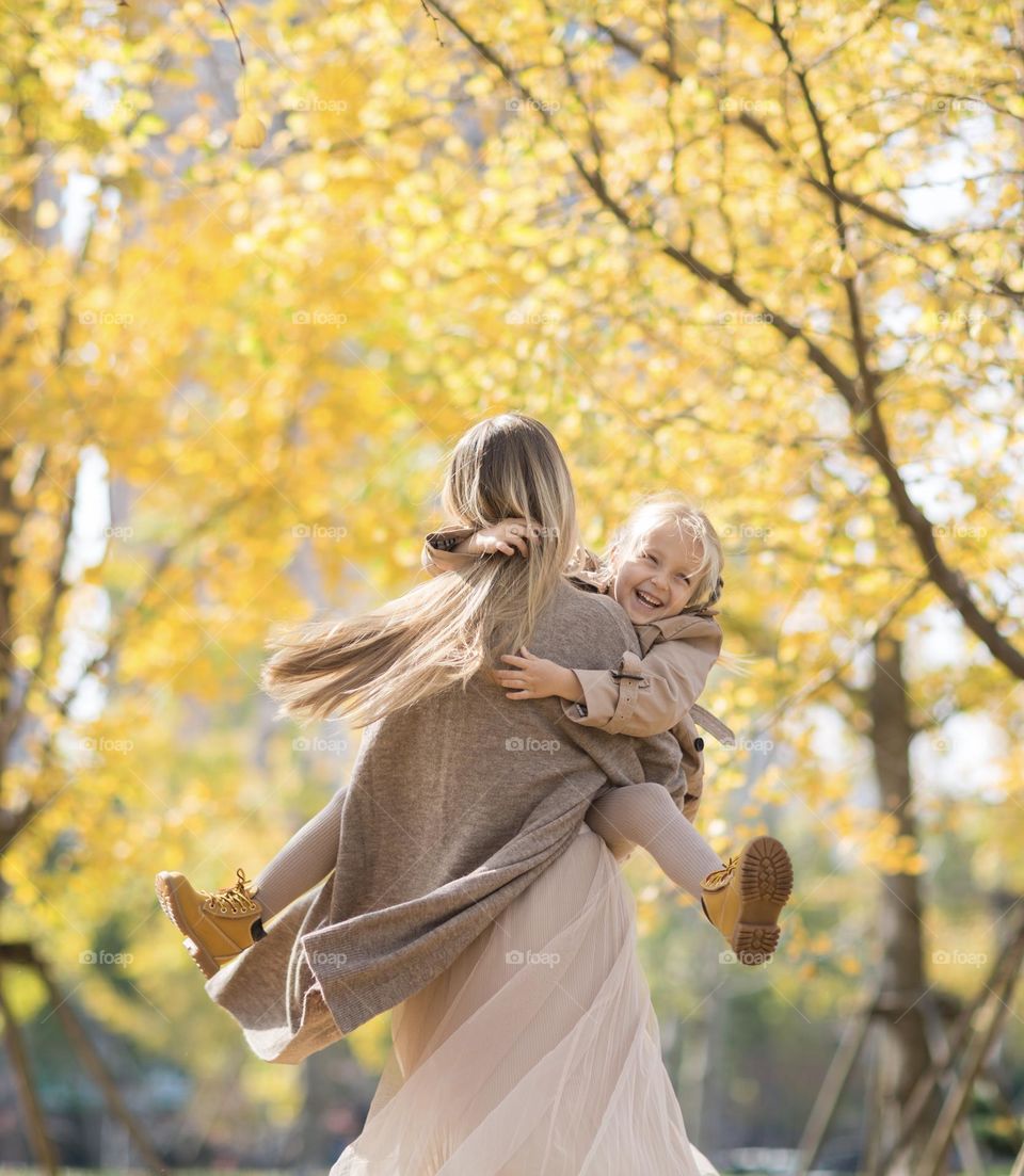 Mother with daughter in autumnal park