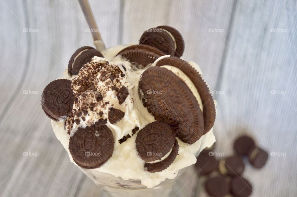 Oreo cookie milkshake with a wooden rustic white background