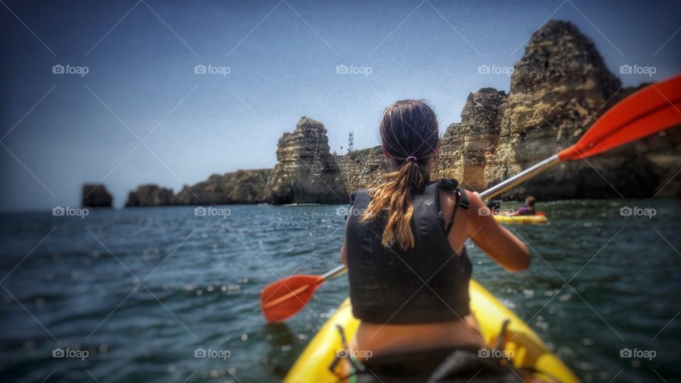 Sea Kayaking in Lagos, Portugal. Beautiful summer day, perfect weather to tour inside the sea caves on the coastline. 