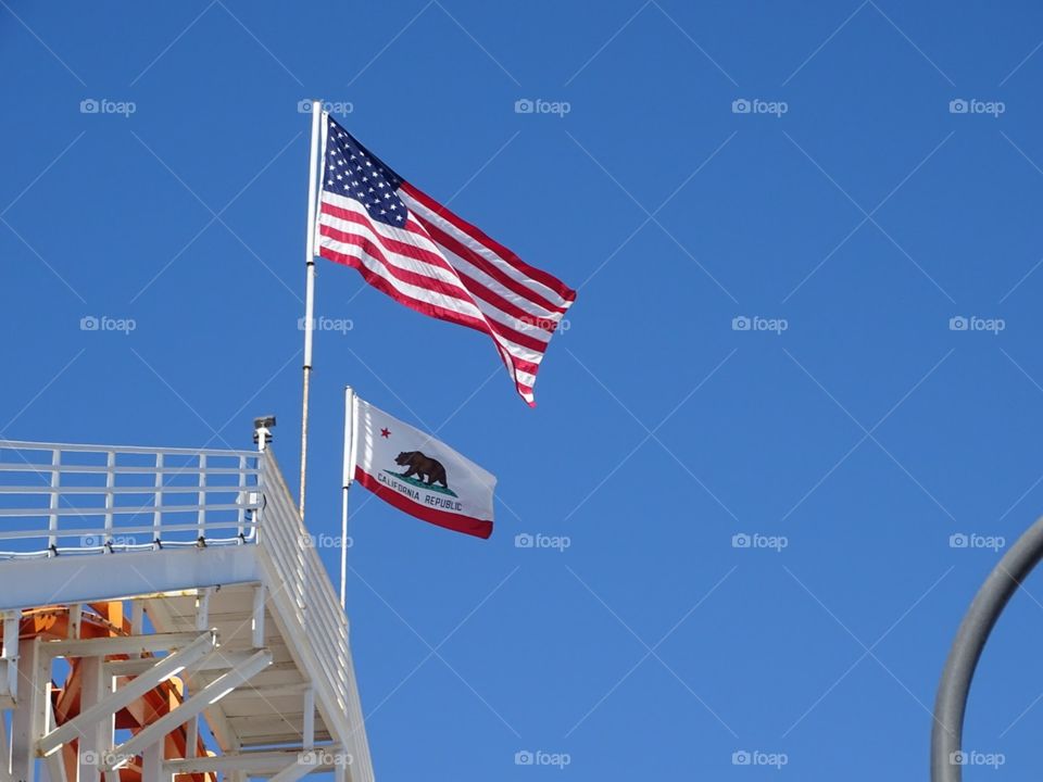 The U.S.A. and California flag waving side by side