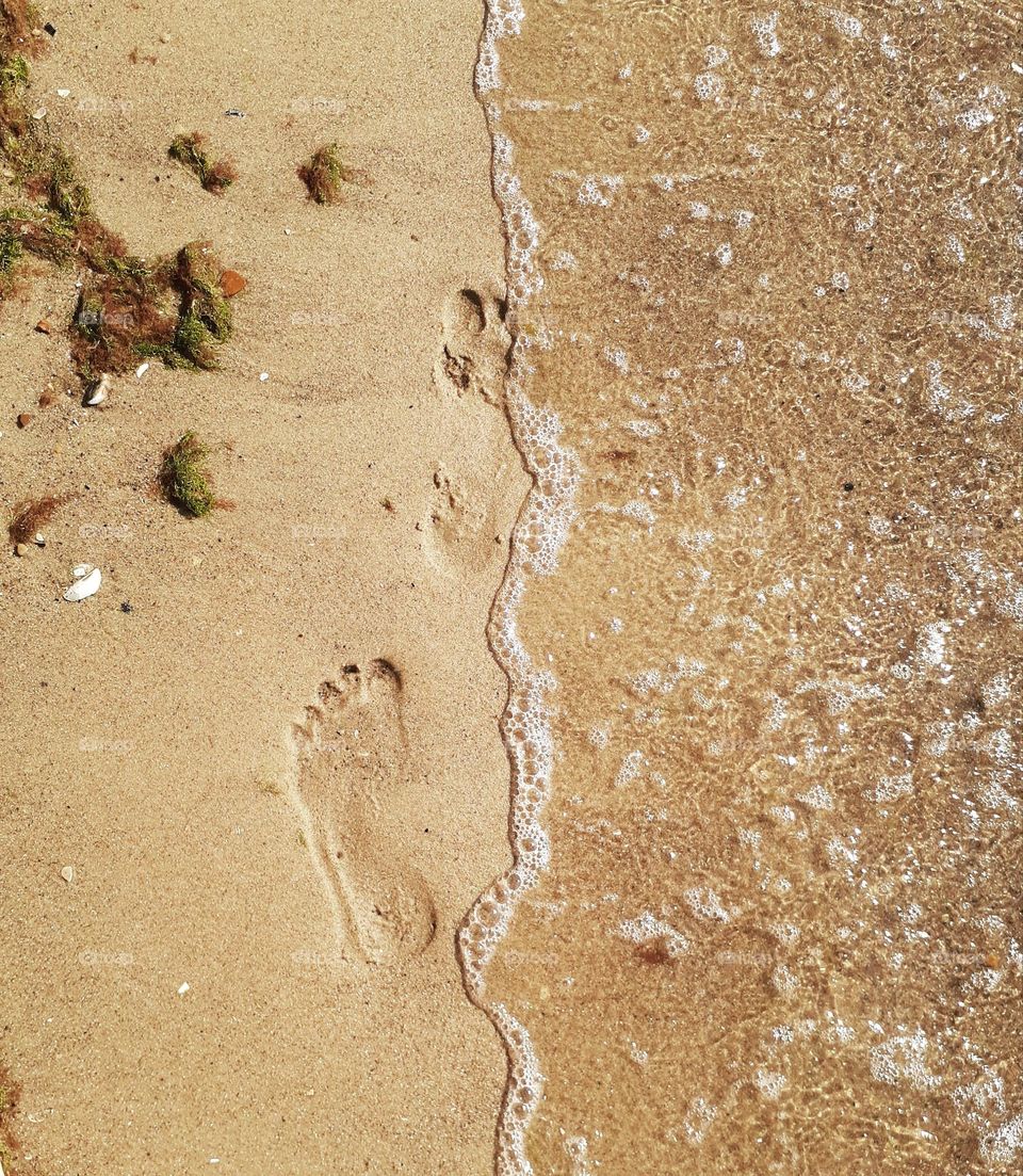 Footprints on the yellow sand