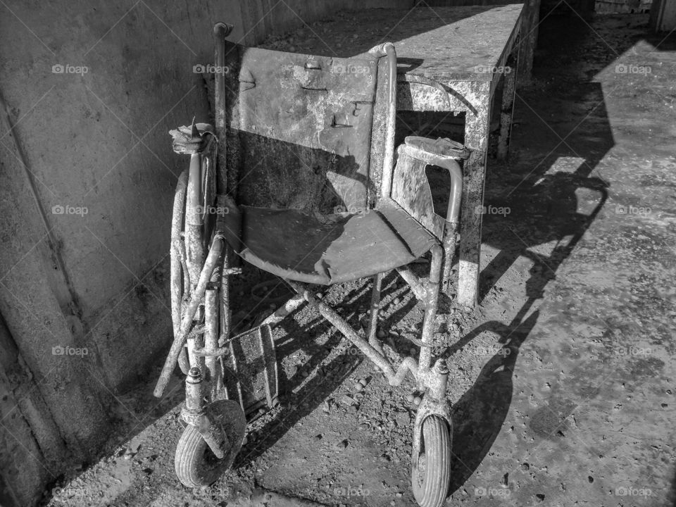 broken wheelchair in black and white