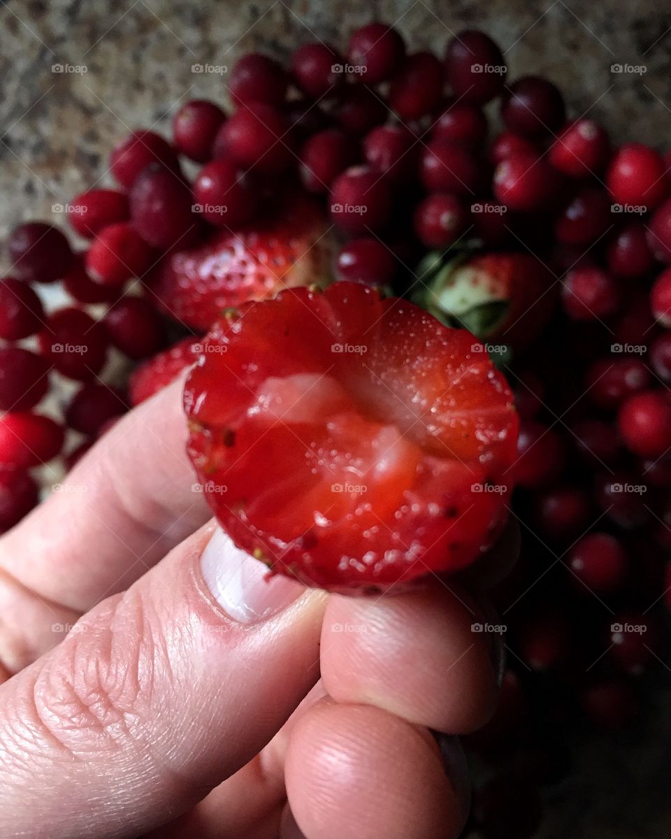 Hand holding strawberry
