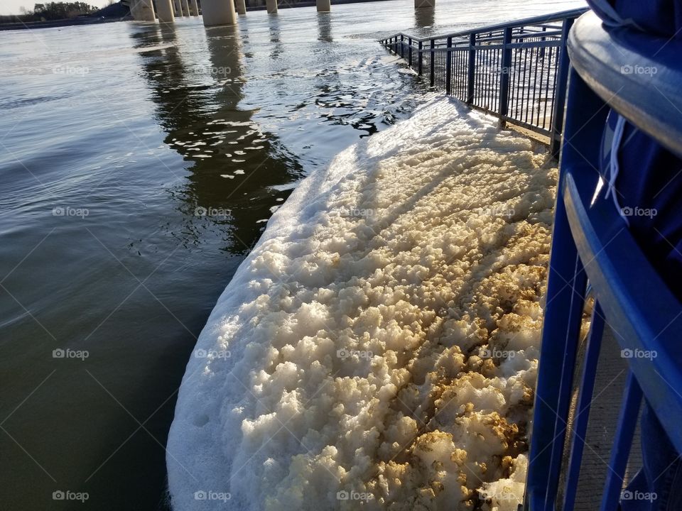 Greenish foam from the rushing waters.