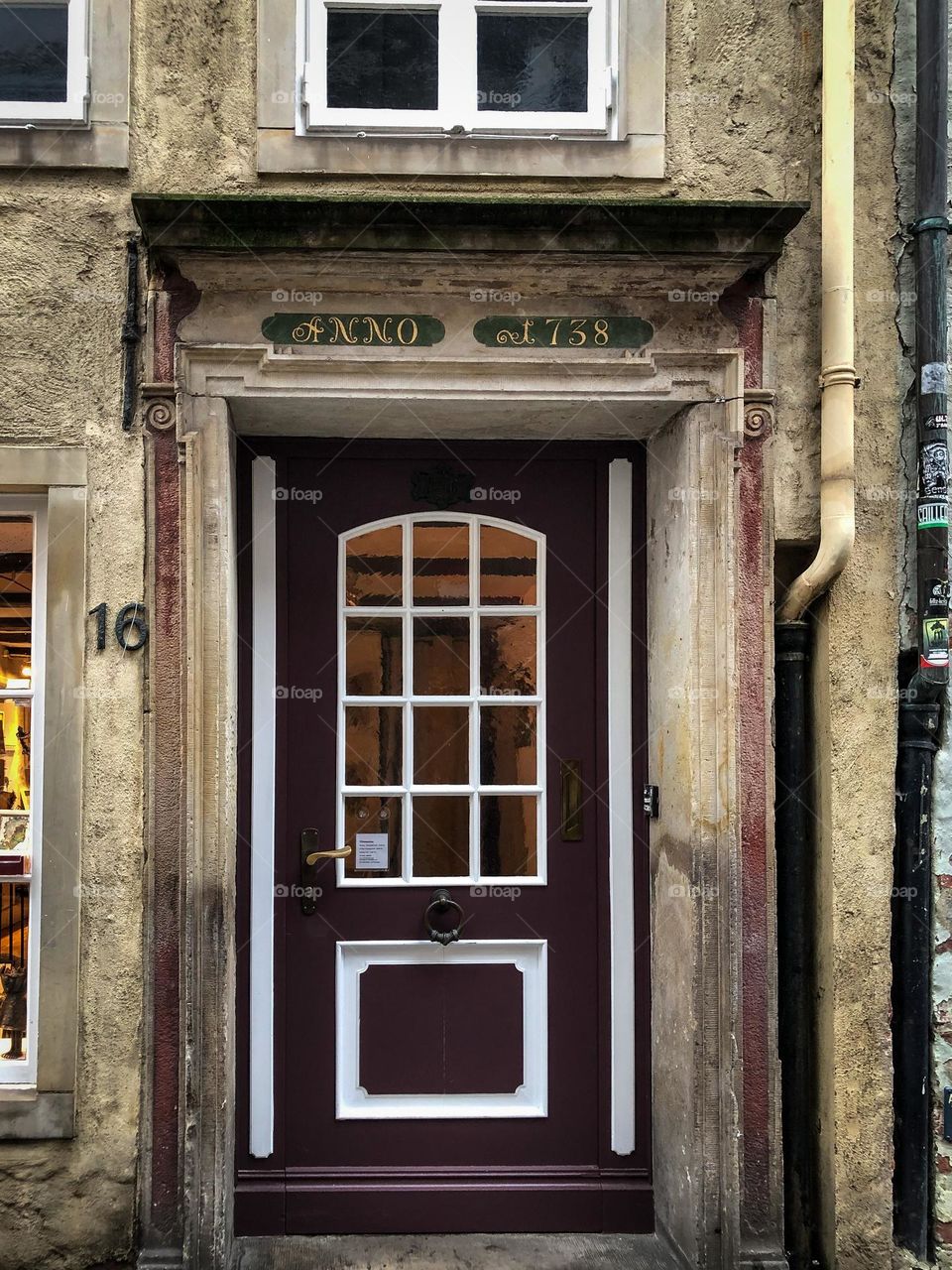 A door of an old house with a plaque indicating the year 1738 on which the house was built.