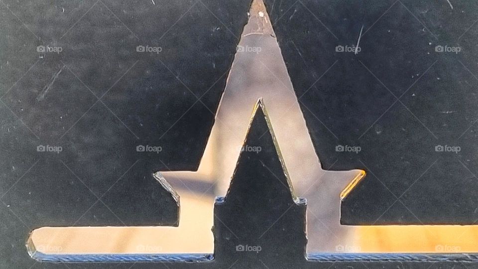 double triangle cut into metal.