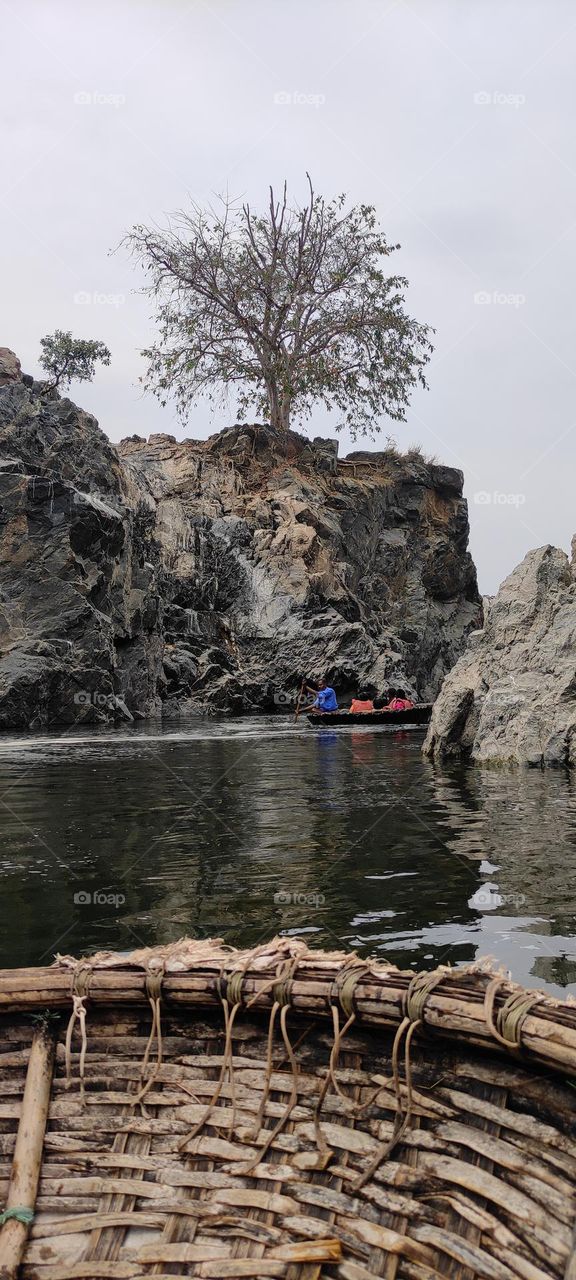 This place is Hogenakkal falls, a waterfall in South India. It is also referred as "Niagara Fall of India". You can see Carbonatite  rocks and water falls in this site.