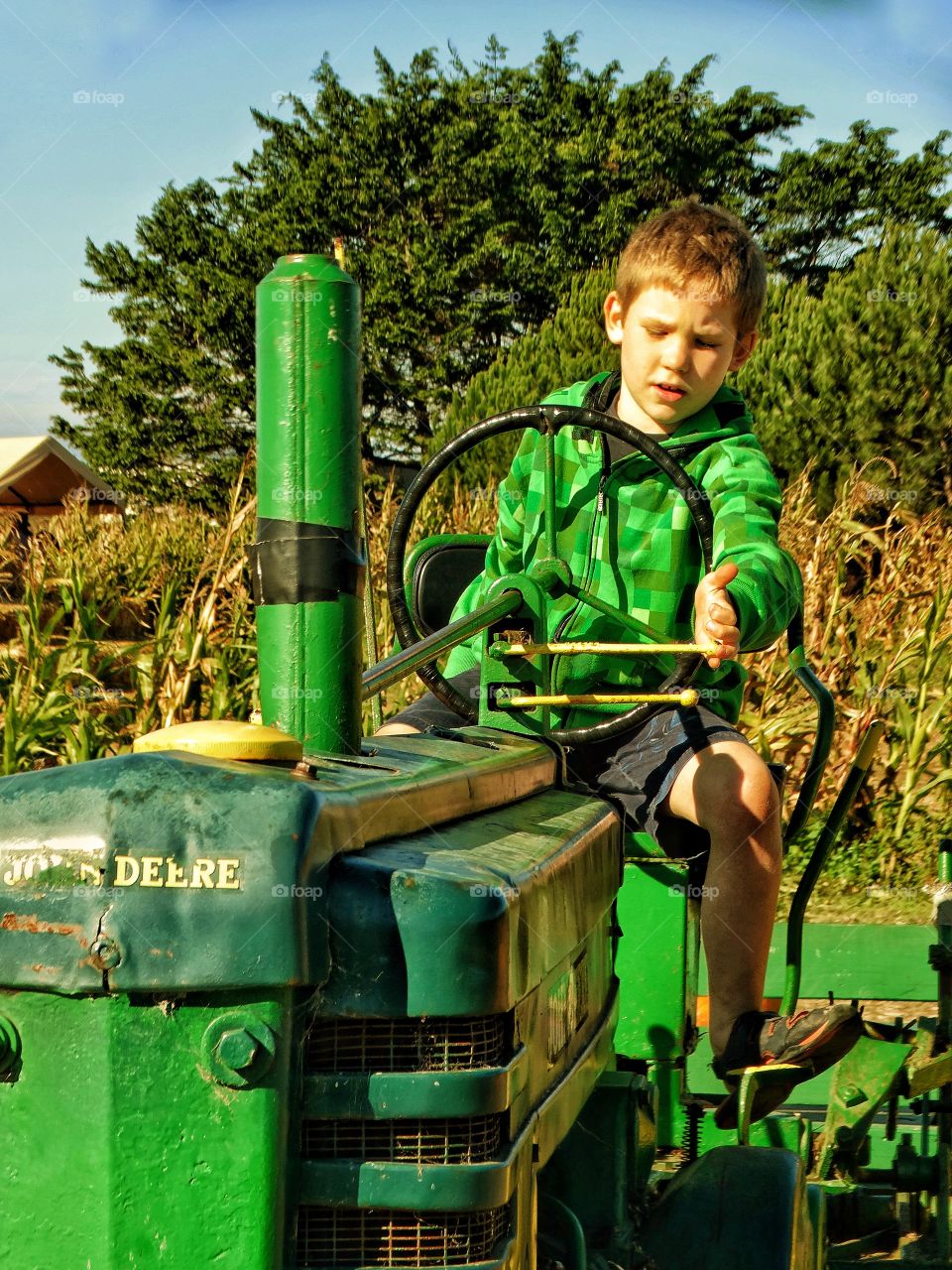 Farm Boy Riding A Tractor