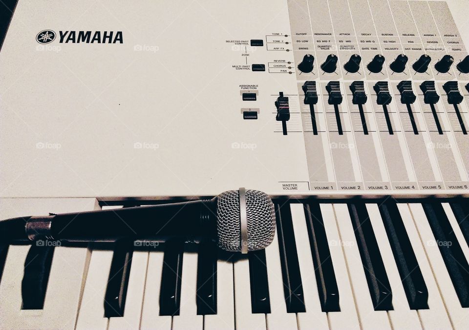 Microphone laying on electronic keyboard