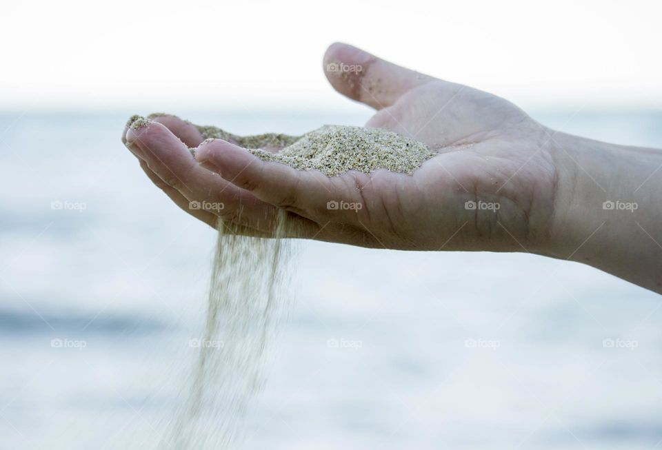 Time passing, sand in a hand