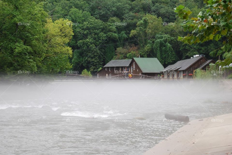 Fog on river town in background