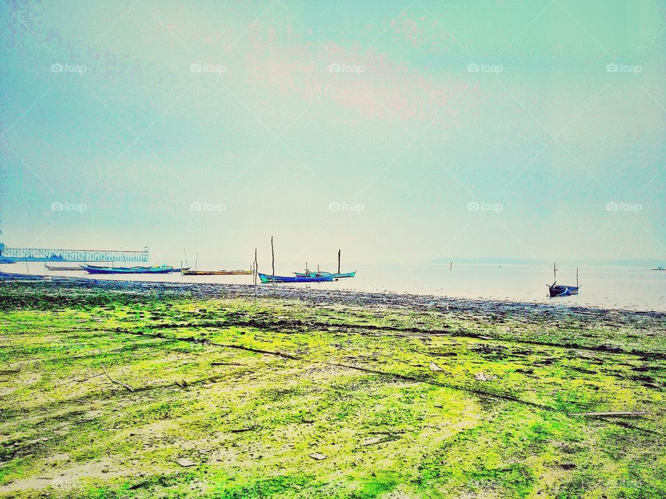 fishing boat.the fisherman are learning on the beach