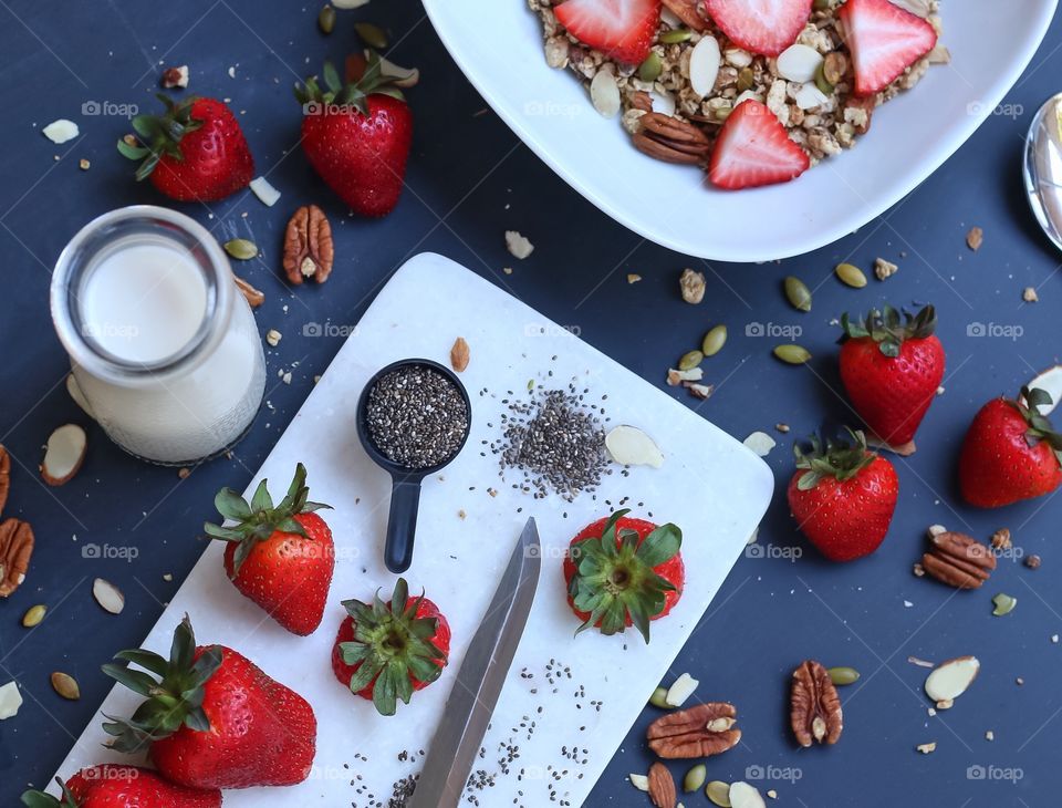 Cereal flatly of strawberries, granola, dried fruits and milk