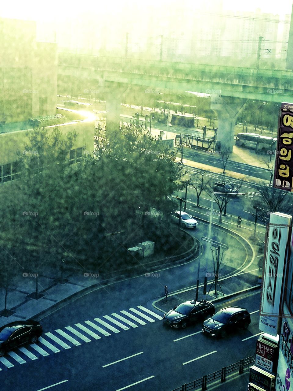 in this pictures it shows the road that shows crossing lines,  the subway above for train and below it is the bus terminal viewed from 5th floor building at yangsan city south korea.