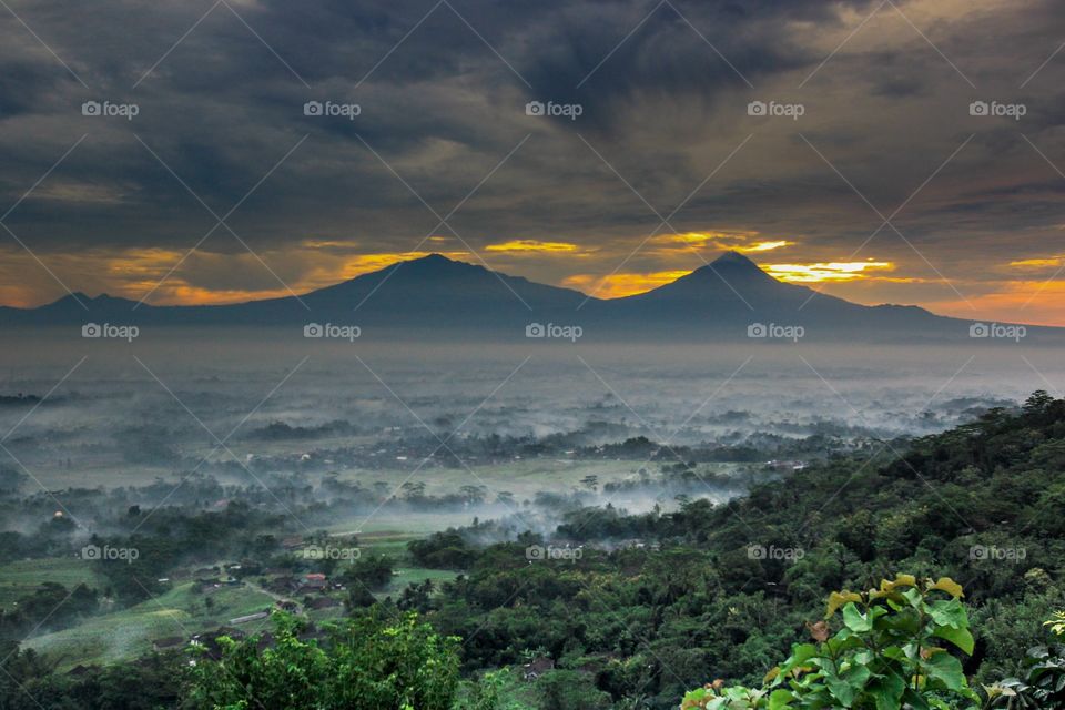 Sunrise over valley in fogy weather