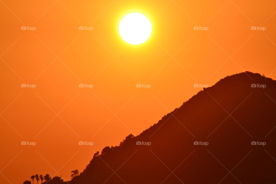 sunset behind mountain