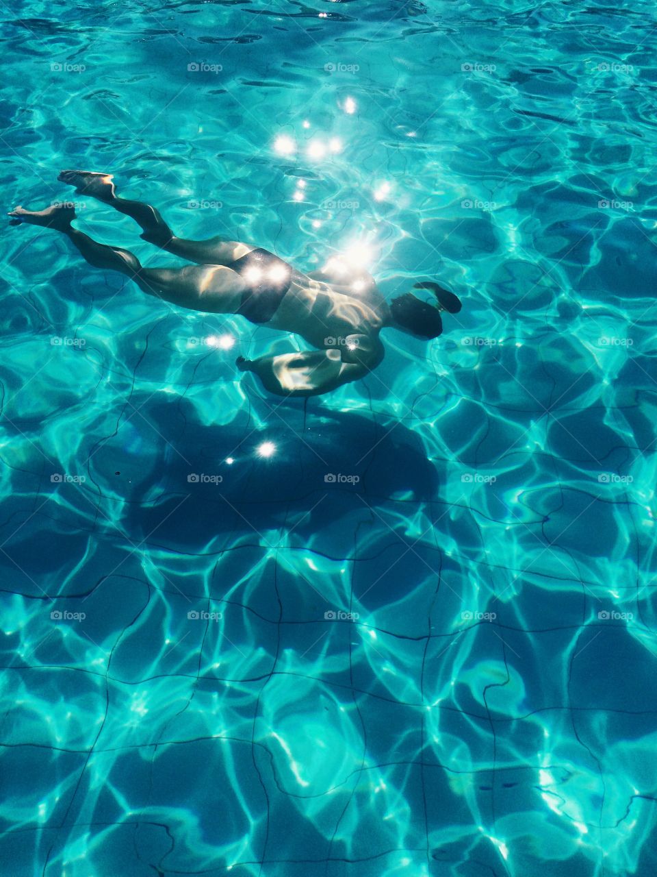 Rear view of man swimming in water