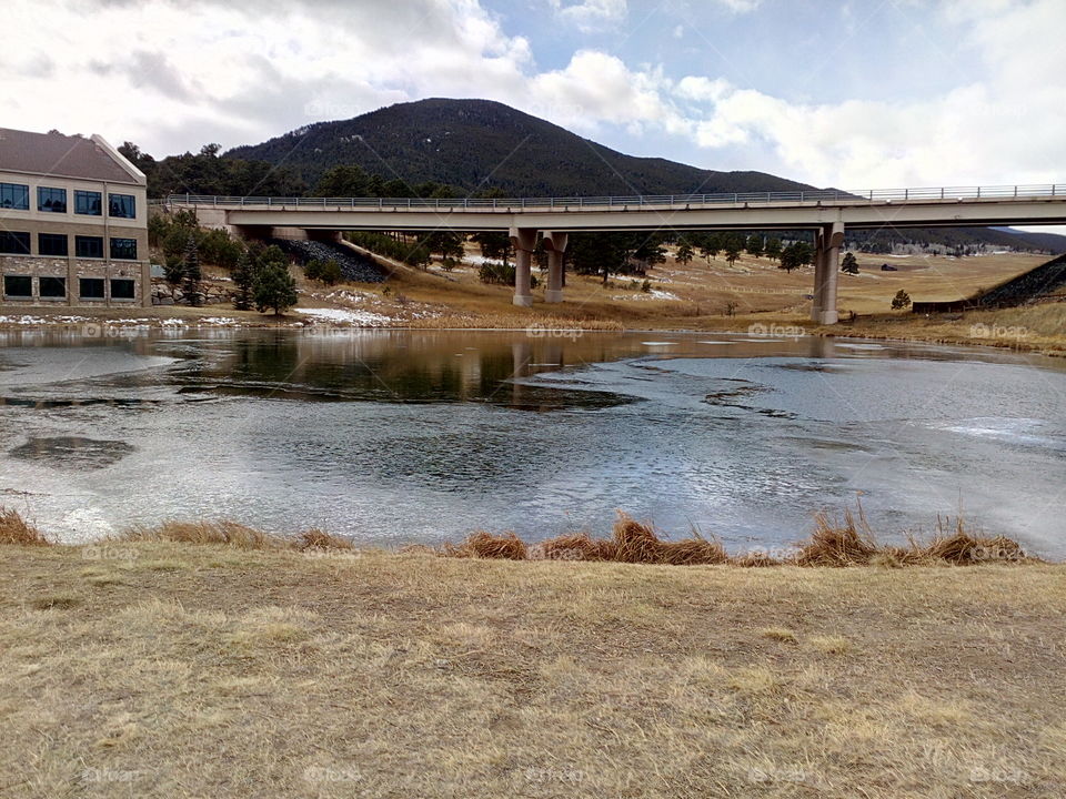 Pond under mountain highway in Evergreen, Colorado