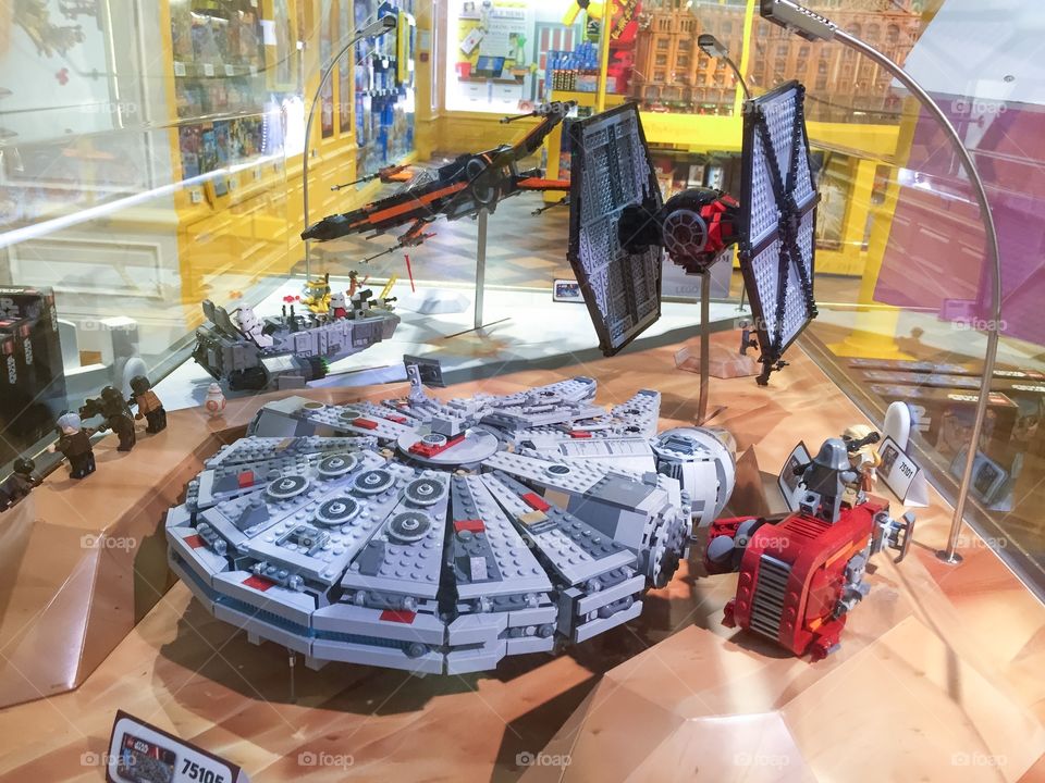 Starwars merchandise toys in a toystore at Harrods in London. Millennium Falcon Built in Lego for display.