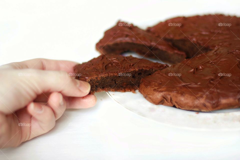 Girl picks up a piece of brownie