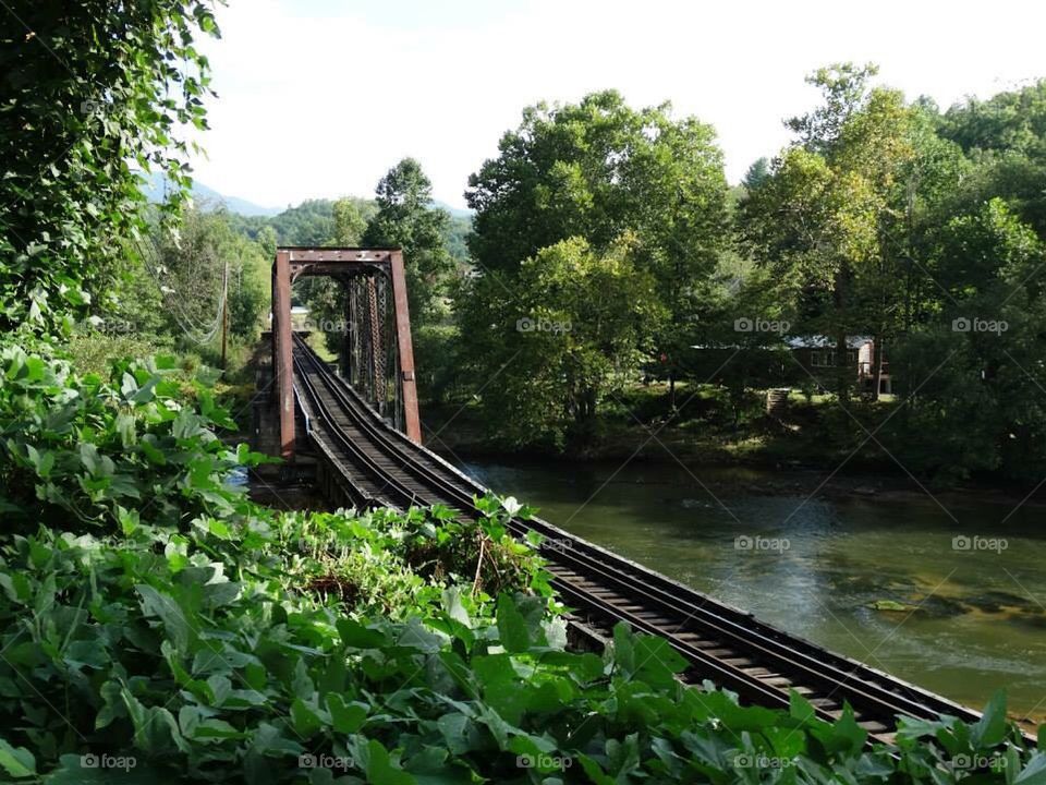 Train tracks crossing river