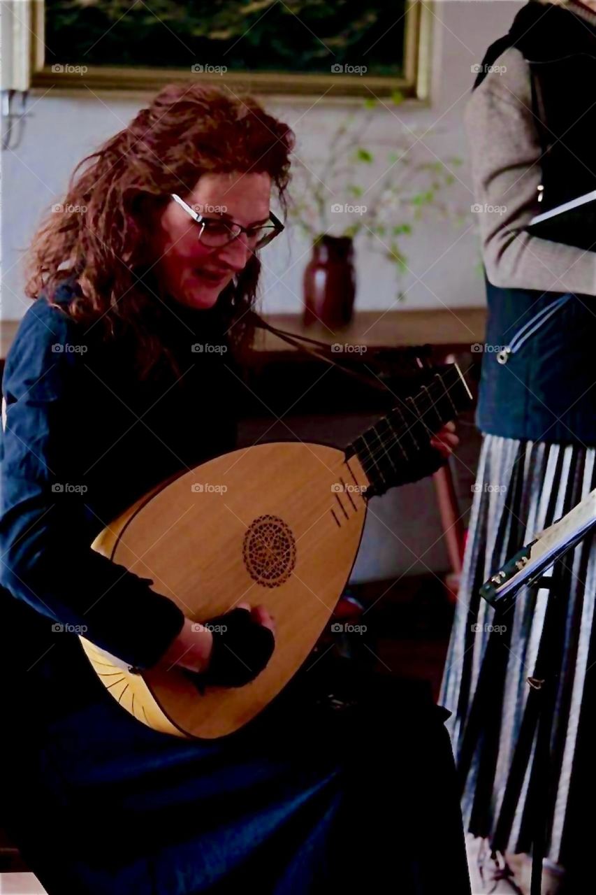 The lovely lady is playing a lute that was custom built after a historical model in her house in “Lower Bavaria”, Germany. 2024. Hypnotic Productions