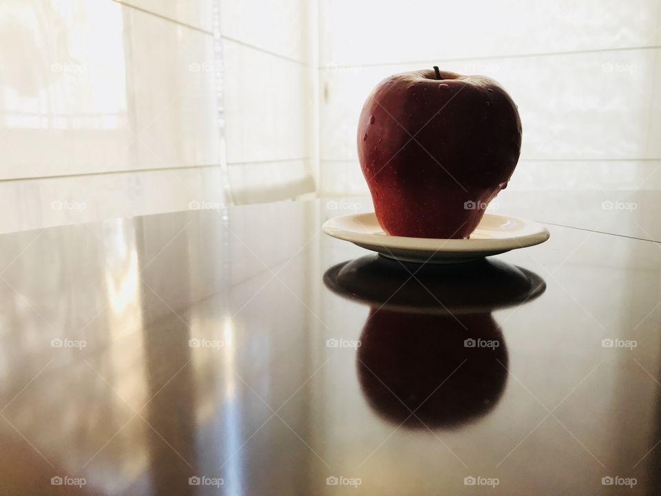 A red apple on a plate