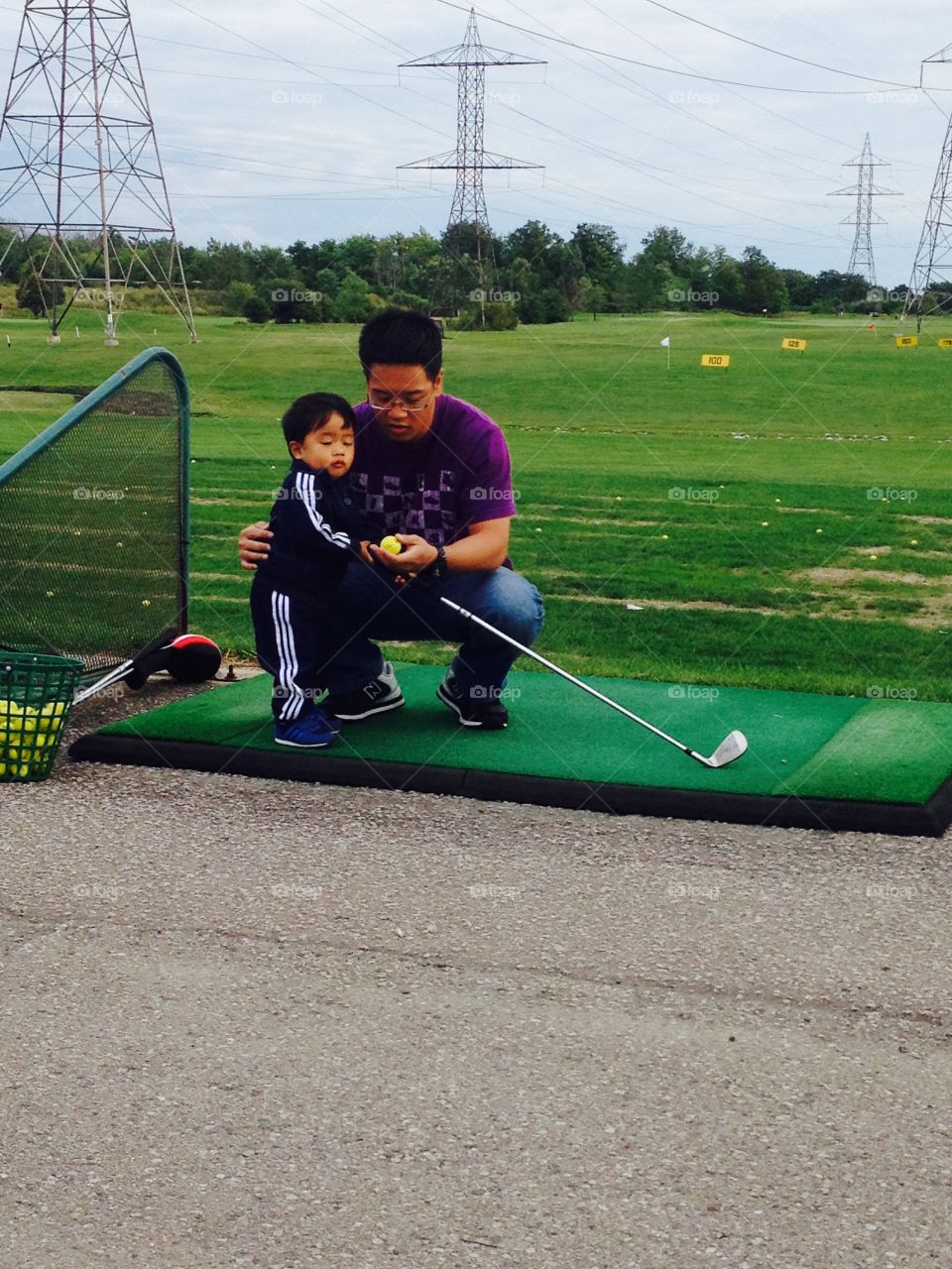 Teaching . Teaching my son golf