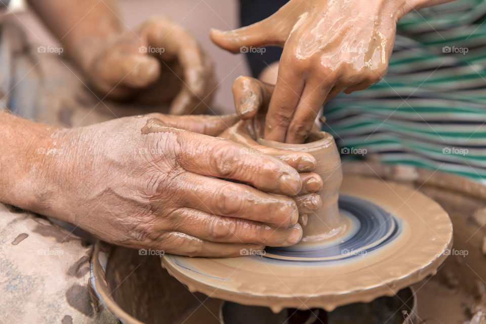 Two people making pottery