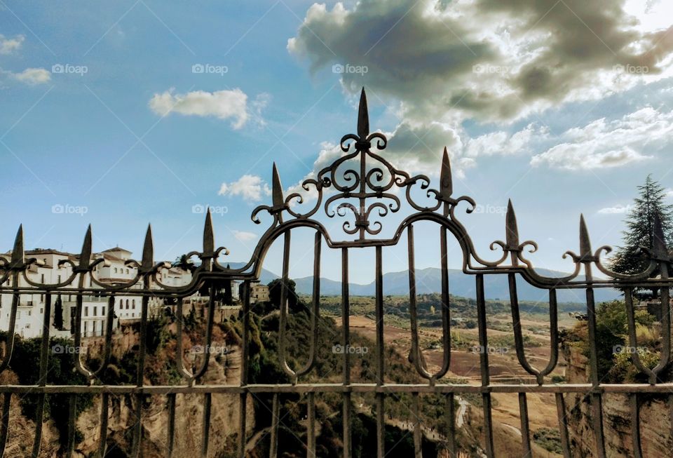 Modern iron fence with sharp points.