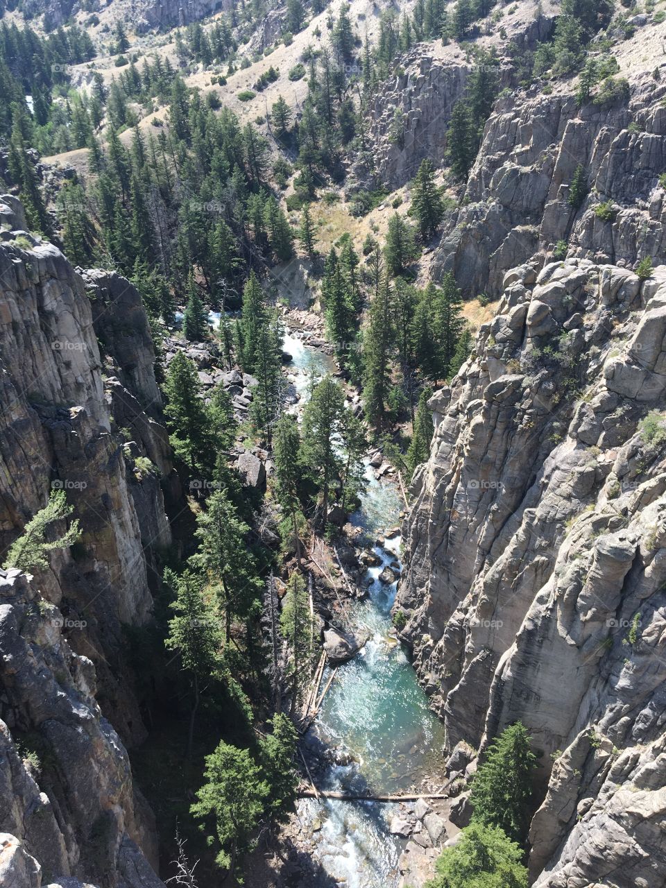 Outside of Cooke City, Wyoming, a huge ravine holds a blue crystal river at the bottom. 