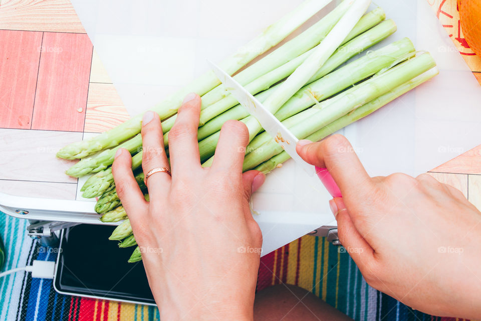 close-up:woman cutting asparagus at outdoor.