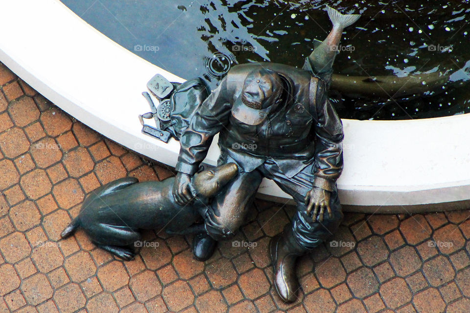 A bronze statue of a fisherman & his faithful dog. It’s outdoors at a hotel where we stayed & is quite the landmark in town. Tourists & residents often stop to sit beside the statue & take pictures. I thought this was a unique view!