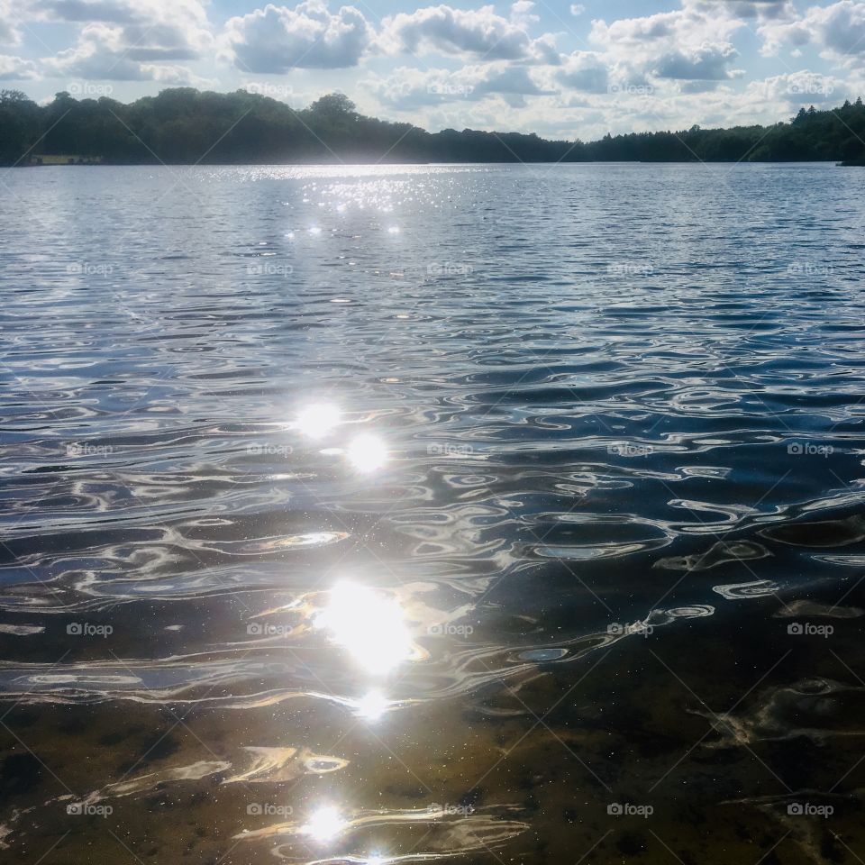 Sun reflecting off the ripples at Virginia Water lake, Berkshire 