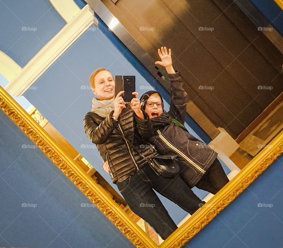 Selfies in the mirror of mom's theater with son.