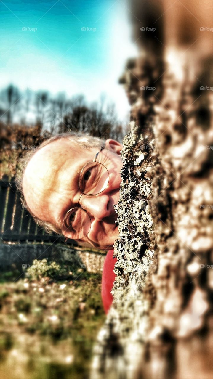 man behind a tree