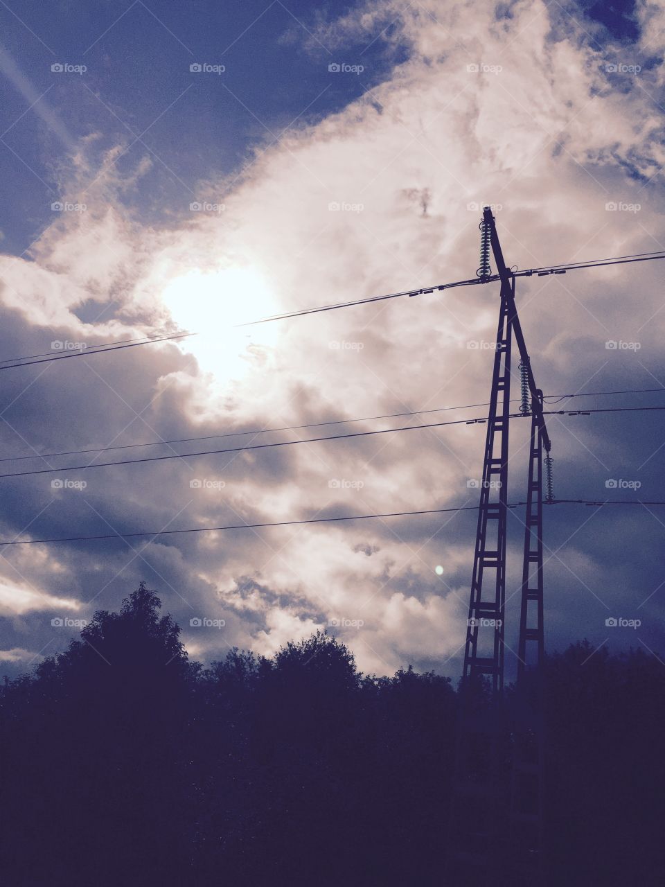 Power lines in the sun. Contrasts in the sky. 