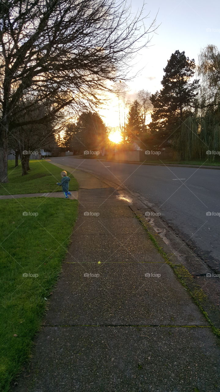 toddler running away from sun set