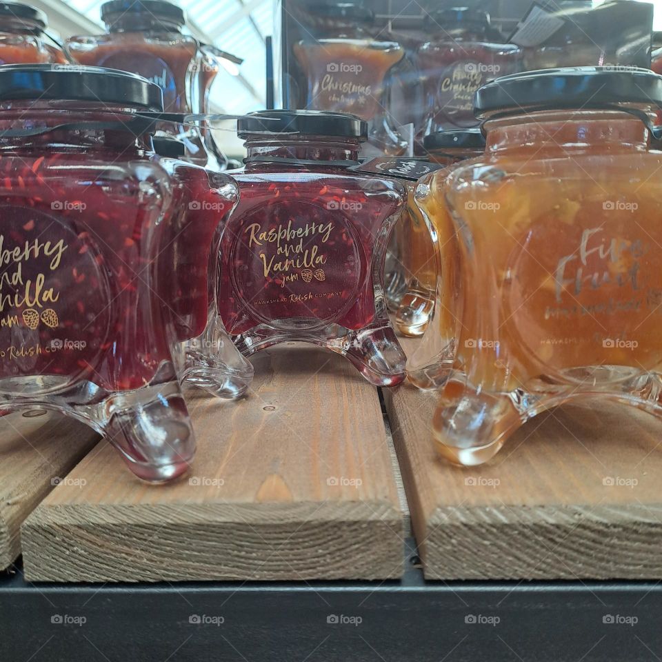 glass jars jam preserves swooden sjelf in shop display