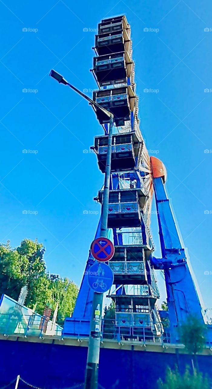 Up closer the individual cabins of the Ferris wheel also become more visible. Each seats approximately six people and the ride is over 100 feet high. Hypnotic Productions