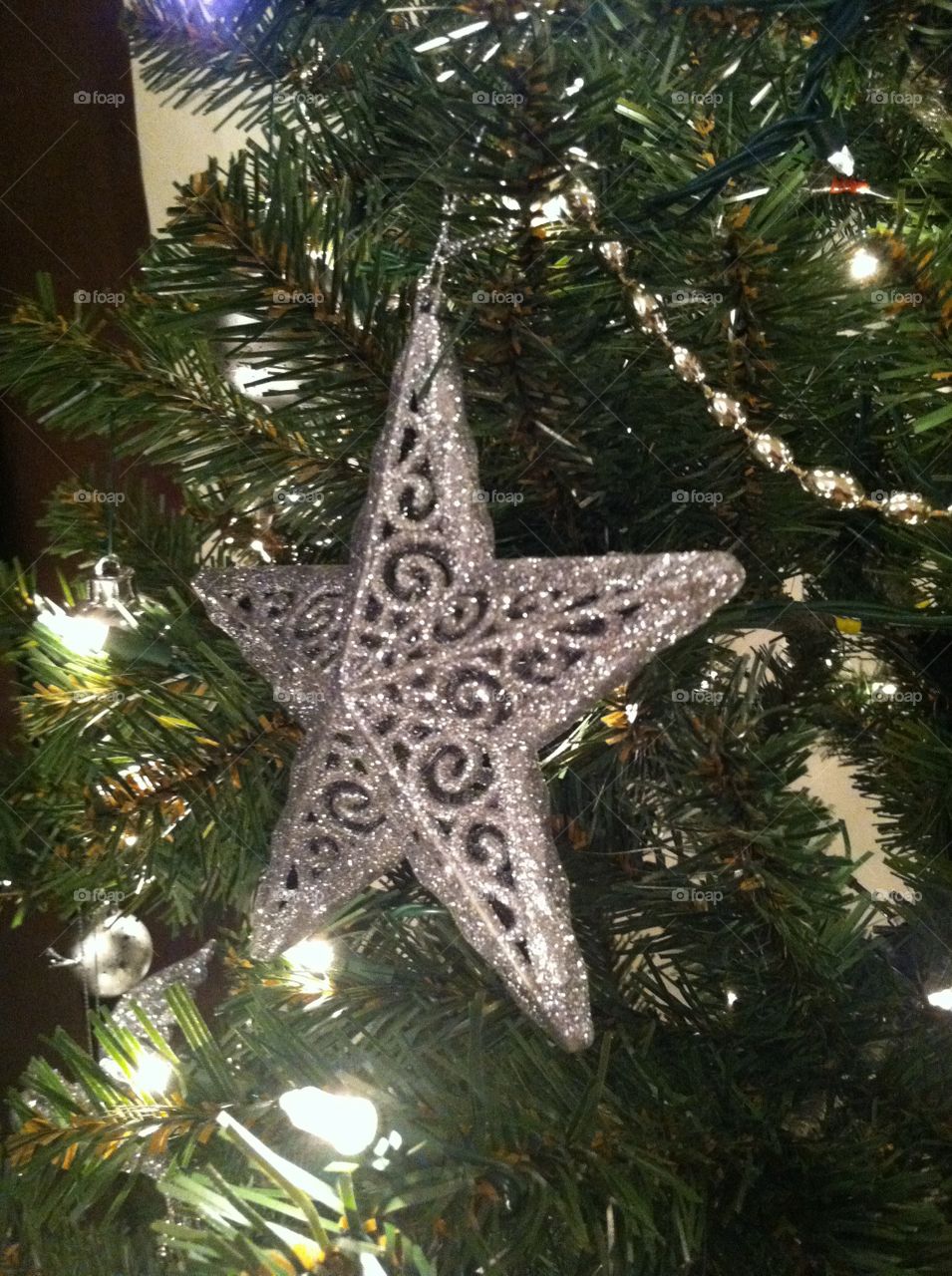 Festive silver star on Christmas tree