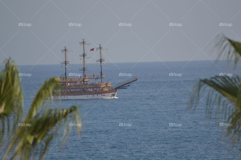 ship sailing close to the beach