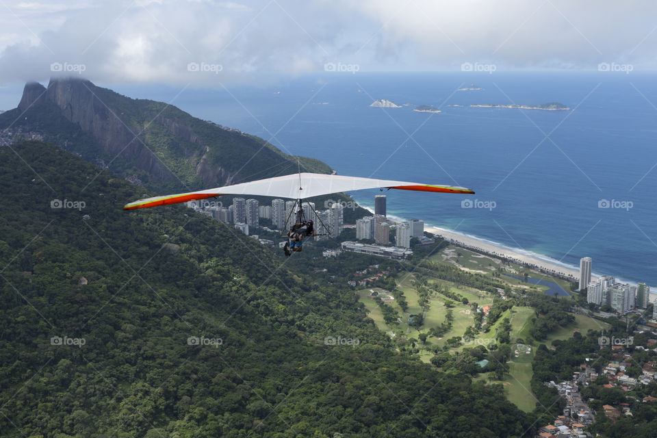 Hang gliding flying over Sao Conrrado in Rio de Janeiro Brazil.