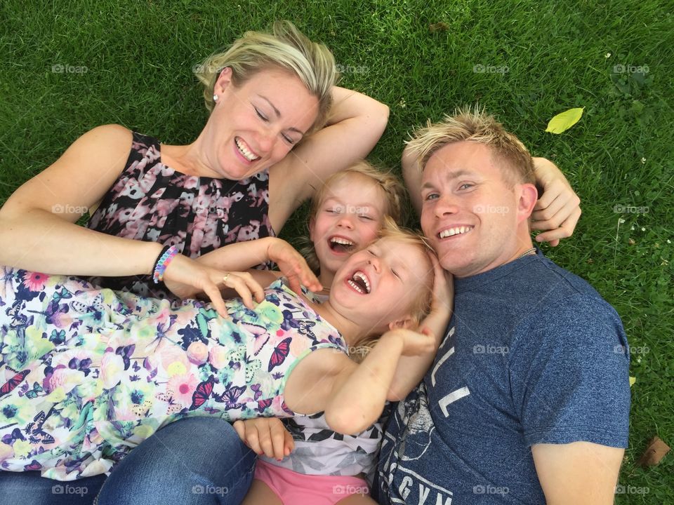 High angle view of family lying on grass